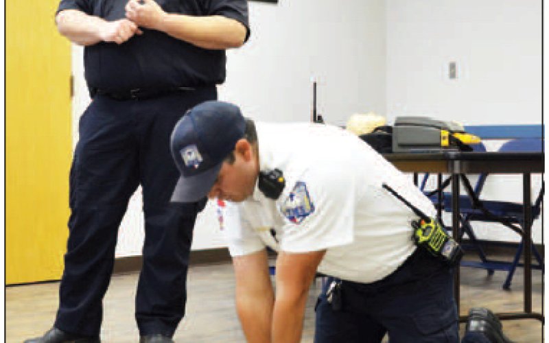 Capt. Jake Tollette explains proper CPR techniques while Asst. Chief Tim Decker demonstrates the procedure during the community CPR class Wednesday, March 30. Photo by Hans Lammeman