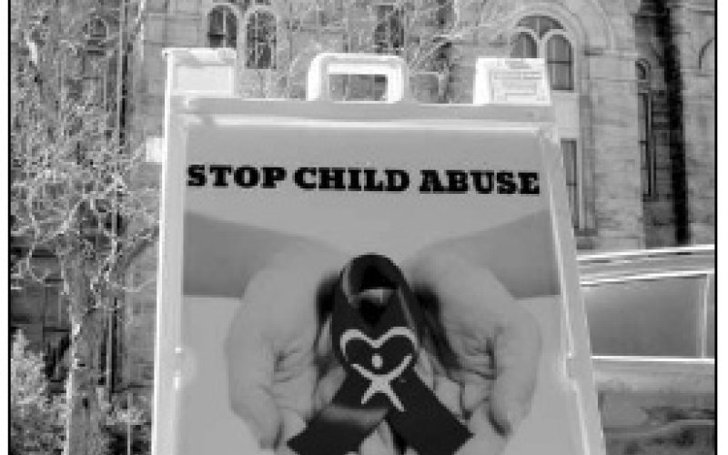 Photo by Hans Lammeman A sign from Golden Crescent CASA outside the Lavaca County Courthouse displays the information for the Texas Abuse Hotline.