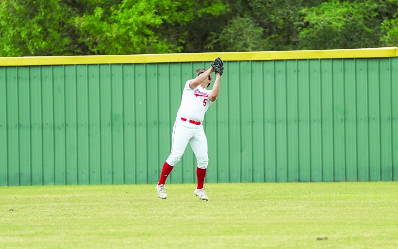 Kade Leist catches a fly ball against Sacred Heart during the Cardinals’ shutout win April 19. Photo courtesy of Photos by Lori Raabe.