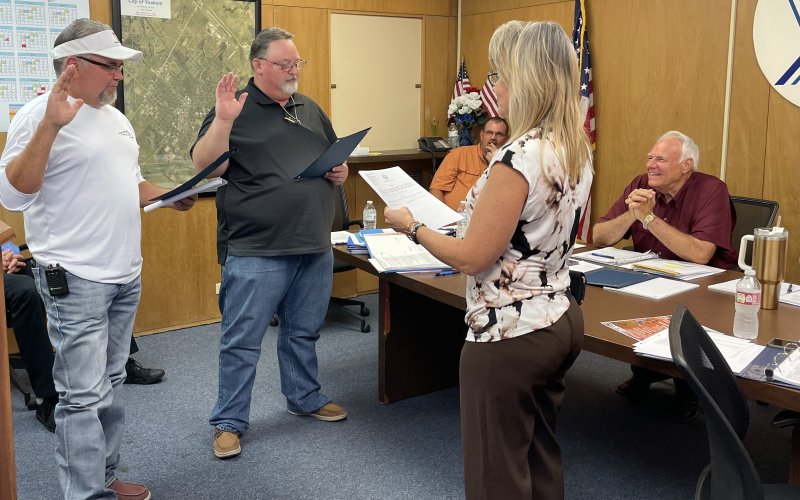 (Left) John S. Pelech and Michael Brandt repeated the oath office administered by City Clerk Theresa Bowe May 10.