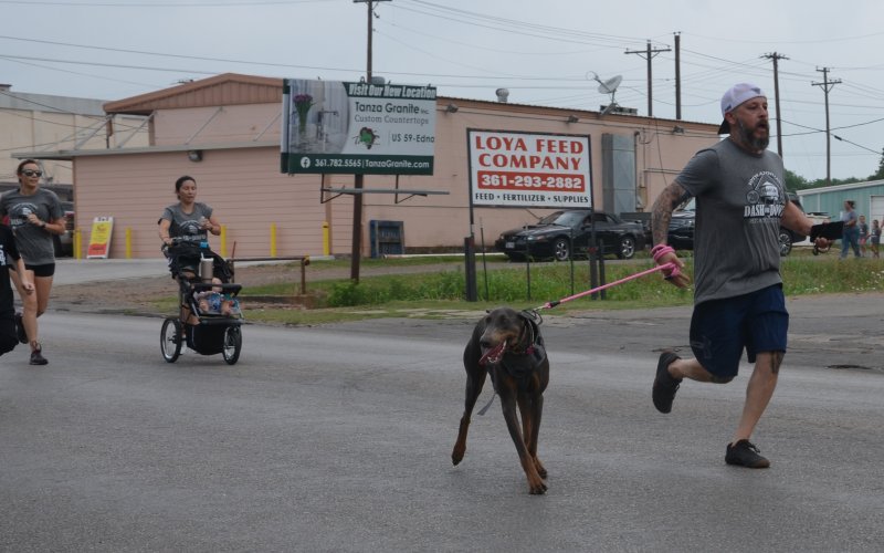 Mike Taylor and his dog Dixie speed up to finish the Dash for Downs 5k.