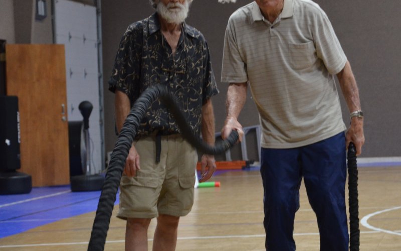 Michael Barnett (left) motivates Glen Schulte (right) during exercises on Wednesday, May 4.