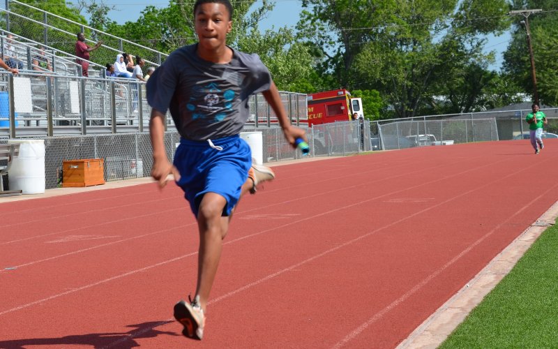 Davon Williams of Yoakum sprints toward the finish line to earn his team first place in the 4x100-meter race.