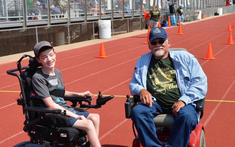 Andrew Yetersky and DLSEC Executive Director Brian Billstein pose for a picture after a 25-meter obstacle race.