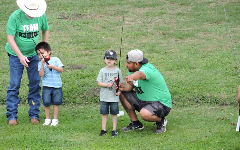 Kodiak Gas Services representatives assist Parker Perez and Troy Penuelaz at the RISE Reel Fishin event held April 28.