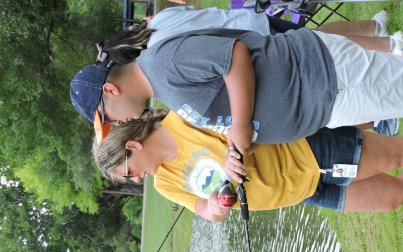 Karen Pawlik (left) and student Israel Vasquez (right) wait patiently for a fish to bite at the 8th annual RISE Reel Fishin event.