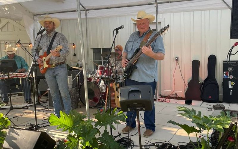 John Wayne Schulz performs outside the Yoakum Heritage Museum for the reveal of the YCH exhibit May 12.