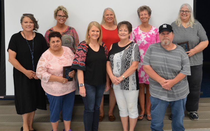 Nine of the 12 2022 YISD retirees pose together on Friday, May 27.