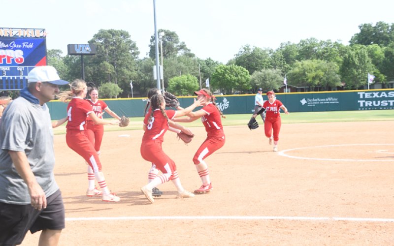 Lady Cardinals gather to celebrate after the final out of the game. Photo by Mark Lube.