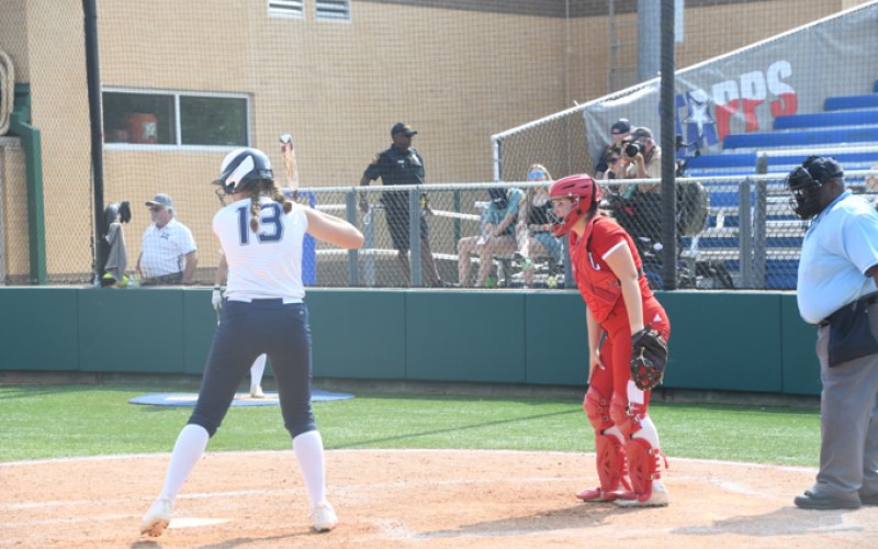 Senior Emily Pilat played catcher in the sixth inning in her final sports competition as a Lady Cardinal. Photo by Mark Lube.