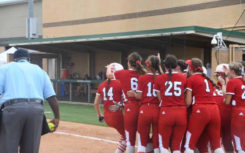 Senior Sydney Green is congratulated by teammates after her second inning jack on Saturday. Photo by Mark Lube.
