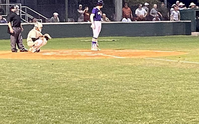Ryan Peterson glances over to head coach Daniel Boedeker at third base. Photo courtesy of James Pustka.