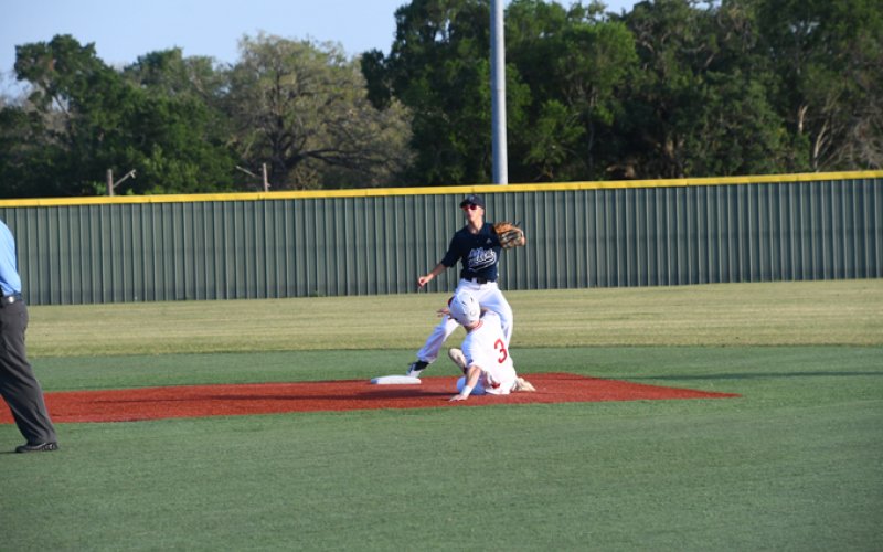 Sean Humes slides into a successful steal of second. The senior had one hit and scored two runs in the state tournament. Photo by Mark Lube.