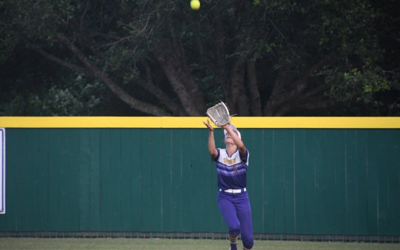 Brinley Ramirez focuses on a fly ball on Saturday. She made two putouts in the second game. Photo by Mark Lube