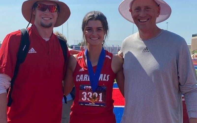 Shiner Catholic School Junior Ashlyn Pesek, shown here Coaches Ryan Geiger, left, and Jake Wachsmuth, won gold at the state track meet in the high jump. 