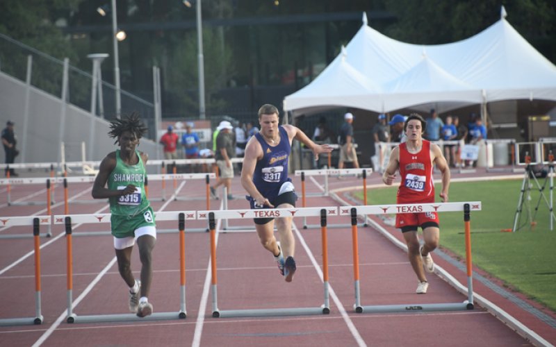 Tyler Bishop approaches one of the last hurdles in the 300 hurdles. Photo by Mark Lube.