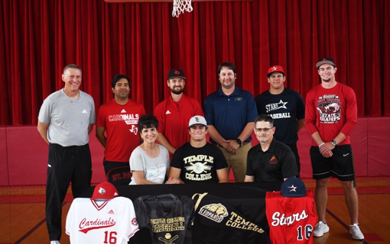 Zak Johnson accepted an offer from Temple College to play baseball. A ceremony was held May 19 to celebrate his achievement. Seated from left is Beth Johnson, Zak Johnson and Ron Johnson.Standing from left is athletic director Jake Wachsmuth, assistant baseball coach Jeremy Rodriguez, head baseball coach Charlie Mieschen, assistant baseball coach Jeff Natho, Blue Hybner and Ryan Geiger. Photo by Mark Lube.