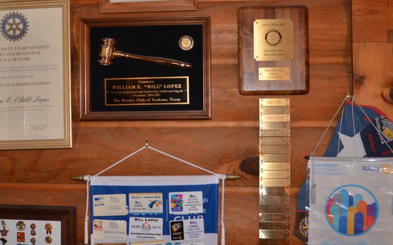 Bill Lopez’s bedroom wall displays awards from several organizations. Photo by Hans Lammeman.