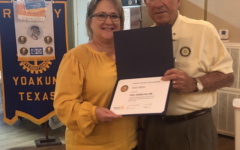 Vicki White hands Bill Lopez a Paul Harris Fellow Award in October 2021. Contributed Photo.