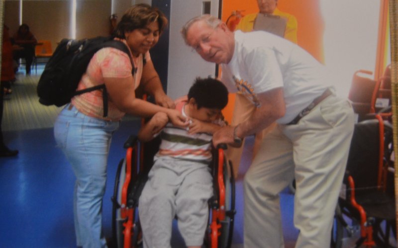 Bill Lopez poses with a child who received a wheelchair donated through a Rotary program in Peru in the early 2000s. Contributed Photo.