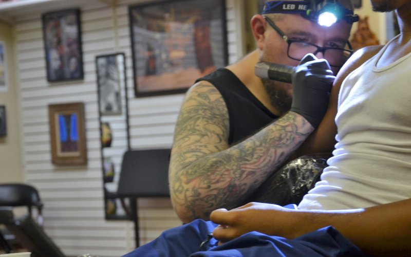 Josh Fluitt tattoos a guest at Yoakum Ink Friday, June 10.