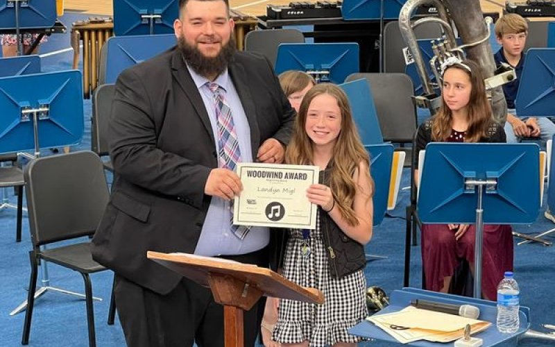 Jacob Heck presents an award to one of his band students over at Sacred Heart schools last school year.