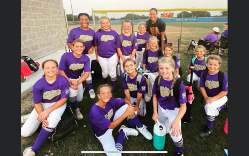 The Shiner Minor League softball team takes a photo with former University of Texas and US National Team pitcher Cat Ostermann. Photo courtesy of Yoakum Herald-Times.