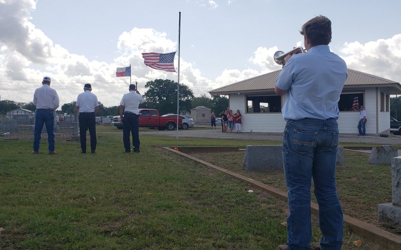 The crowd falls silent as the notes to taps sound across the ceremony.