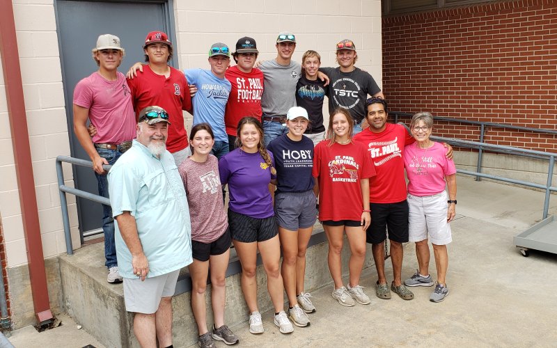 A couple of the workgroups over at the Catholic School gather up for a photo before heading out once more on Wednesday afternoon. Picture are, front from left, the Rev. Bryan Heyer, Emily Moeller, Tori Walker, Julia Machacek, Jessica Fikac, Jeremy Rodriguez and Sharon Patek; and back from left, Hunter Knight, Jackson Ulcak, Nathan Timmons, Carson McNabb, Noah Boedeker, Joseph Davis and Peyton Brown.