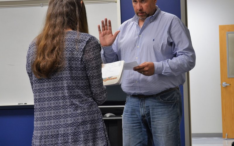 Rodney Svec repeats the oath of office administered by Paula Janota at the June 13 meeting at the YISD Administration Building.