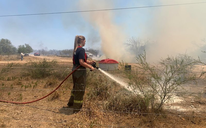 A firefighter extinguishes flames at the scene of the Dry RIce Fire south of Columbus this week. Photo Courtesy Columbus Fire Department.