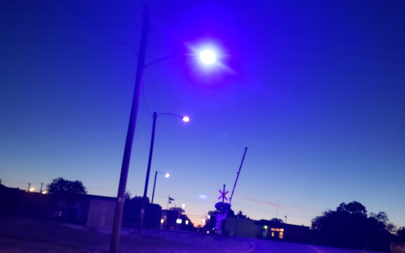 A streetlamp illuminates blue light at the intersection of East Gonzales and South Streets in Yoakum. Photo by Nadine Rex.