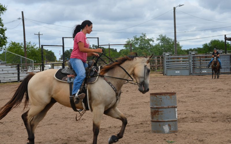 Brittani Richter weaves around barrels at the Yoakum Rodeo Arena Friday, July 15.