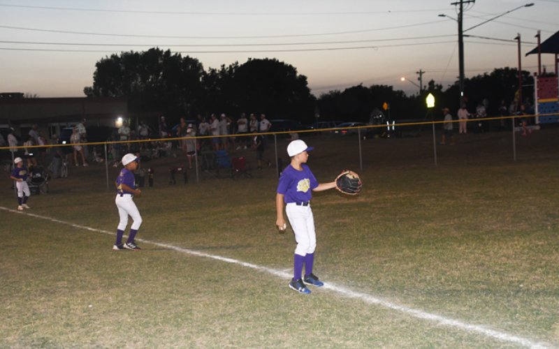 The Shiner Minor Baseball team warms up prior to their July 5 game against Sealy. Photo by Mark Lube.