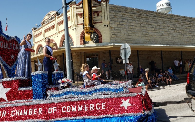 Miss Moulton Hope Kirkland, Junior Miss Alyssa Jasek, Little Miss Emma Henderson and Little Mister Ryan Koncaba make their way around the landmark SouthStar Bank corner in downtown Moulton as part of the 60th annual Jamboree Parade in 2021. Jamboree Week kicks off this weekend with the 2022 Miss Moulton Pageant, starting at 6 p.m. Sunday, July 23, at the Legion Hall.
