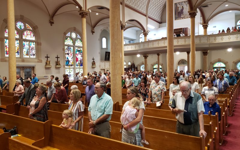 Parishioners lift their voices in song for the day’s centennial celebration in Shiner. Aside from the vast arches of that ceiling and remarkable colors throughout, I particularly like having captured that painting, way back there above the choir loft. With so much else to fill your eye in this place I’m betting that has to be one of the most underappreciated works in the whole building.