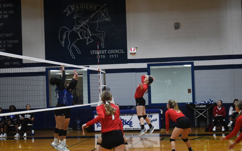 Emily Stamport jumps up for a kill attempt in St. Paul’s two-set win over Rice Friday morning at the Rice Tournament. Photo by Mark Lube.