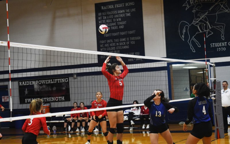 Ashlyn Pesek tries to block a Rice ball. Photo by Mark Lube.