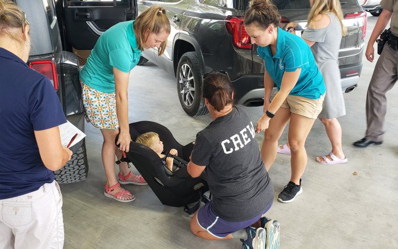 Inspection specilists review every element of the car safety seat with their owners.