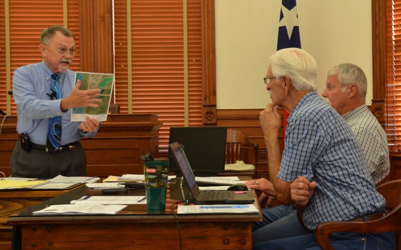 DeWitt County Judge Daryl Fowler holds up a map displaying flood zones Sept. 13. Photo by Hans Lammeman.
