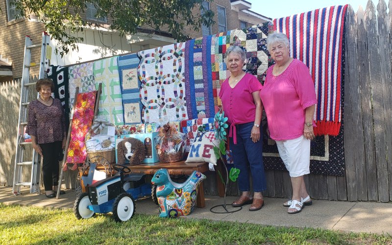 Pictured with just a few of the great items that will appear in Sunday’s action are, from left, Rose Selzer, Joyce Pavlicek and Gussie Machalec.
