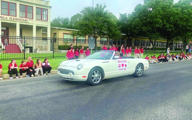 Shown in the photo is the grandparent of 1st grader Briggs Gindler as she rolls slowly past the junior high students