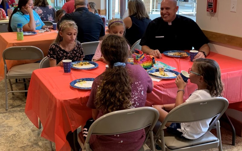 Pictured is Pastor Chris Heinhold enjoying a meal with children at Wednesday evening GIFT.