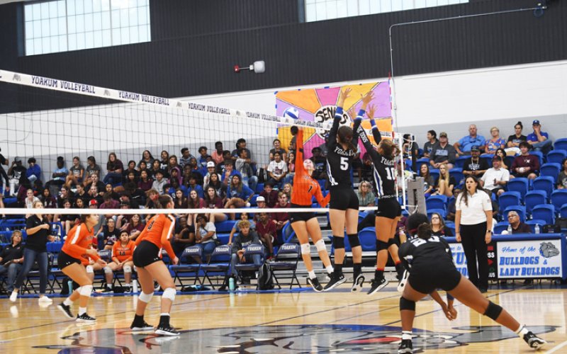 Addison Pekar and Samantha Adamek attempt a block in the Sept. 6 match against Gonzales. Yoakum has won their first two district matches.