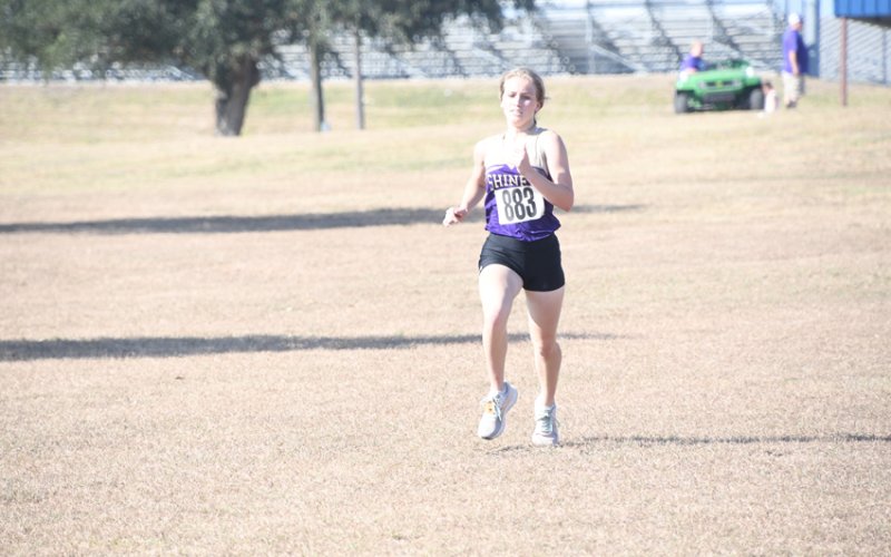 Hayleigh Burns and the rest of the Shiner Lady Comanches run late Friday morning at the state cross-country meet in Round Rock.Photo by Mark Lube.
