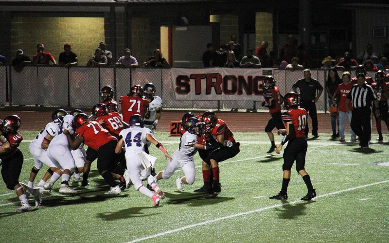 Jake Davidson makes a tackle while Hunter Knight comes in to assist. Photo courtesy of John Davidson.