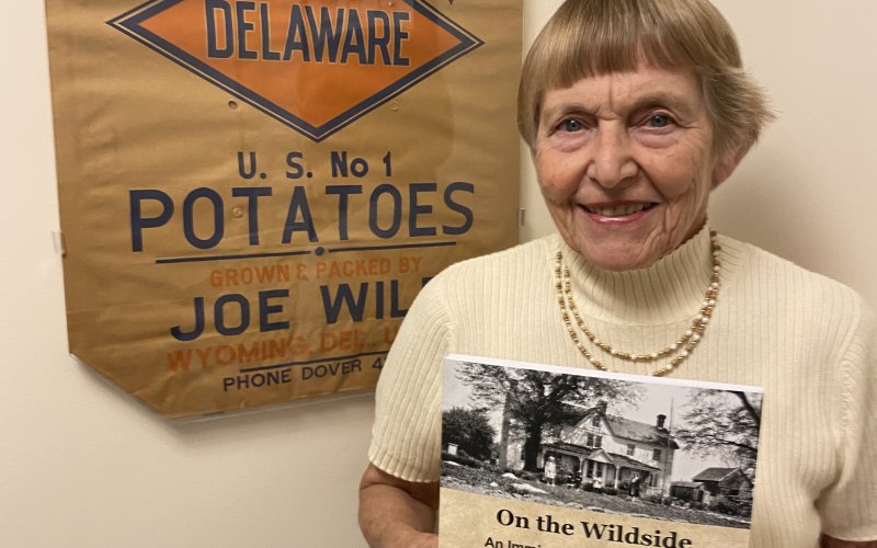 Doris Zumwalt stands beside one of the old paper sacks that was used on their potato farm in Delaware. Contributed Photo.
