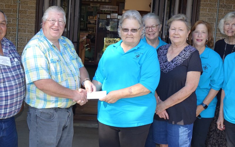 Pictured are, left to right, Assistant Museum Curator Roy Rivera, Museum Curator Duff Wagner, Guild President Janet Ferguson, Guild members Mary Shafer, Beverly Svetlik, Carolyn Hilscher, Toni Rogers and Irene Cerny.