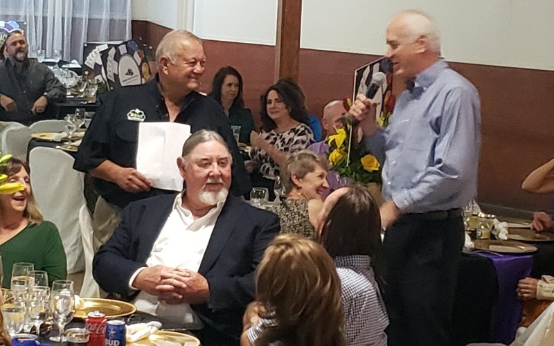 Robert Werner makes his way through the crowd, just before dinner is served Saturday, to rub elbows with some of the day's largest donors toward the Old Shiner Gym projects. Seated in the foreground is Mark Hagens, owner of H&amp;C Construction. The tall fellow standing there is Douglas Kaspar, son of Dan Kaspar and now the namesake to his charitable foundation.