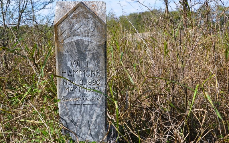Grave stones peak above the vegetation at the Yoakum Colored Cemetery at the Intersection of Dunn and Jackson Streets in Yoakum. Photos by Hans Lammeman